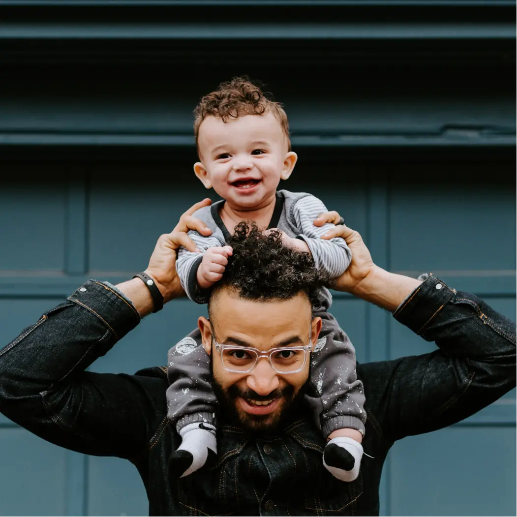 father with a baby on his shoulders