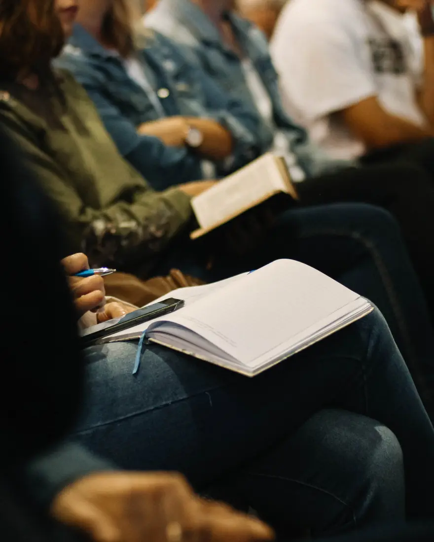 Group of people sitting together with notebooks