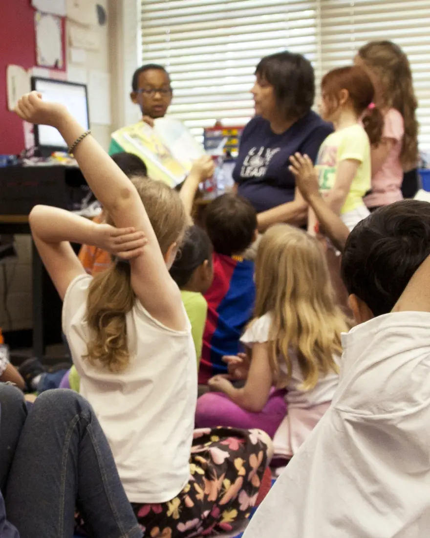 Children and teacher in a classroom setting
