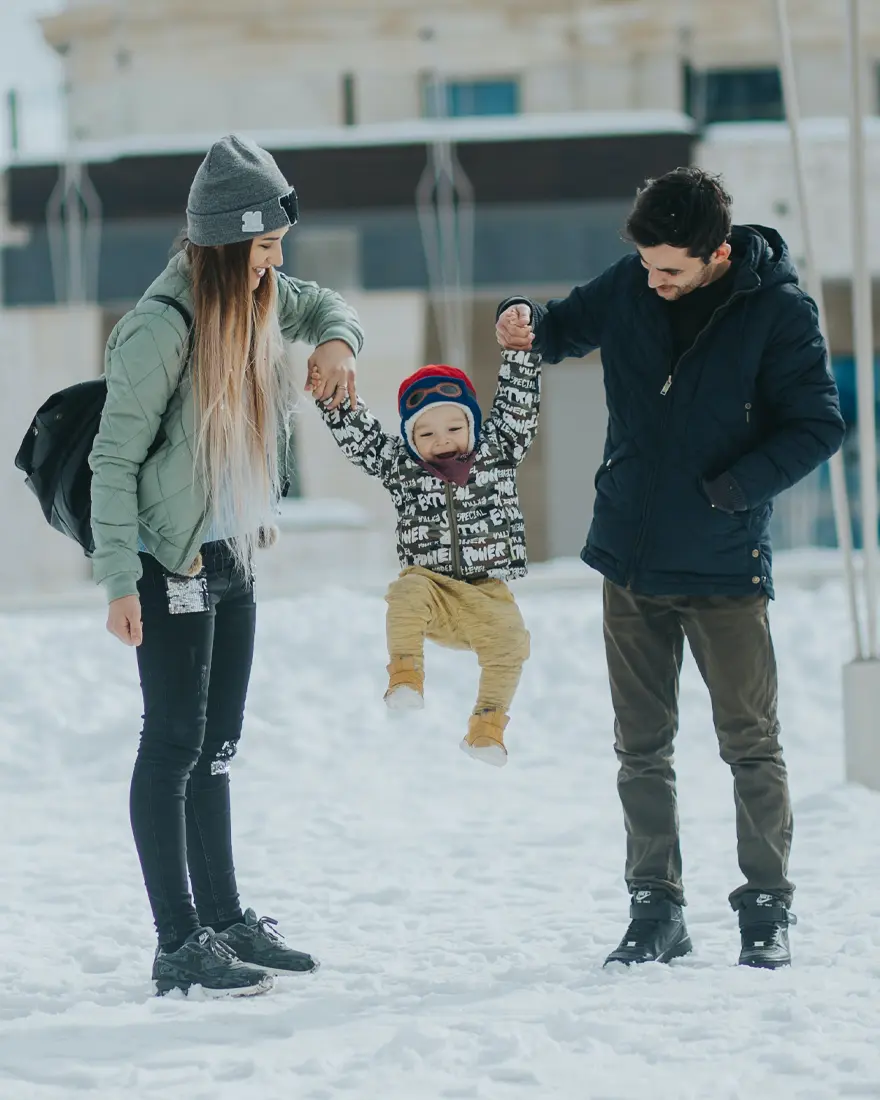 Couple with young child in the snow