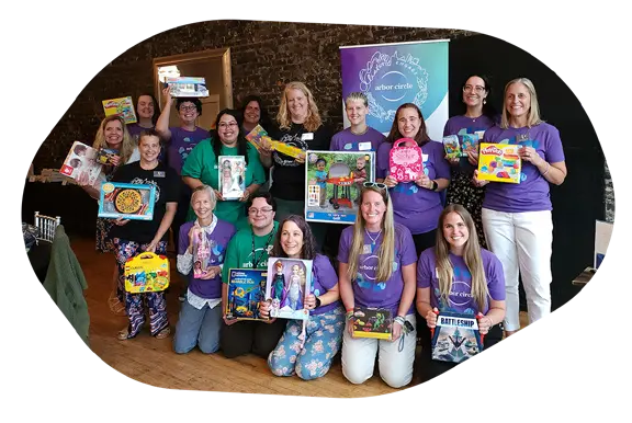 Arbor Circle staff holding gifts for children