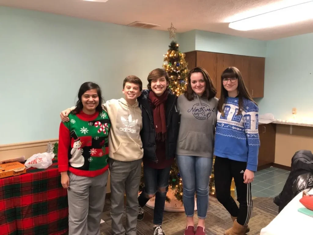 Students wearing holiday sweaters