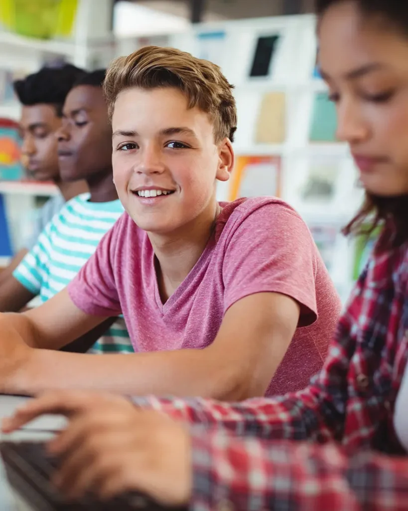 Group of youth on laptops in classroom